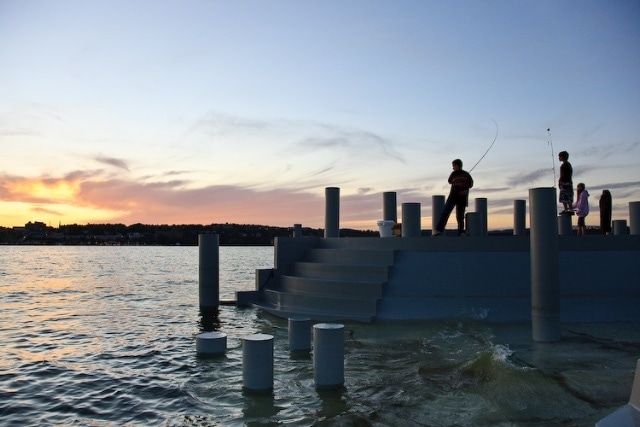 A person fishing at sunset in the Hudson River at Scenic Hudson's Long Dock Park.